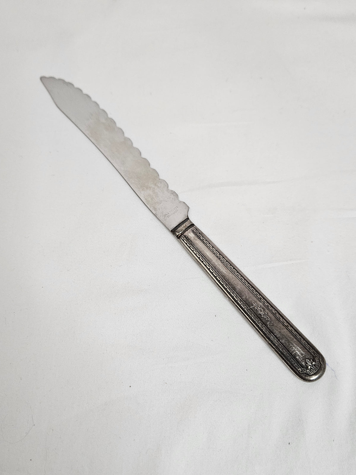 Vintage WM A Rogers serrated cake knife with an S monogram, 10 inches