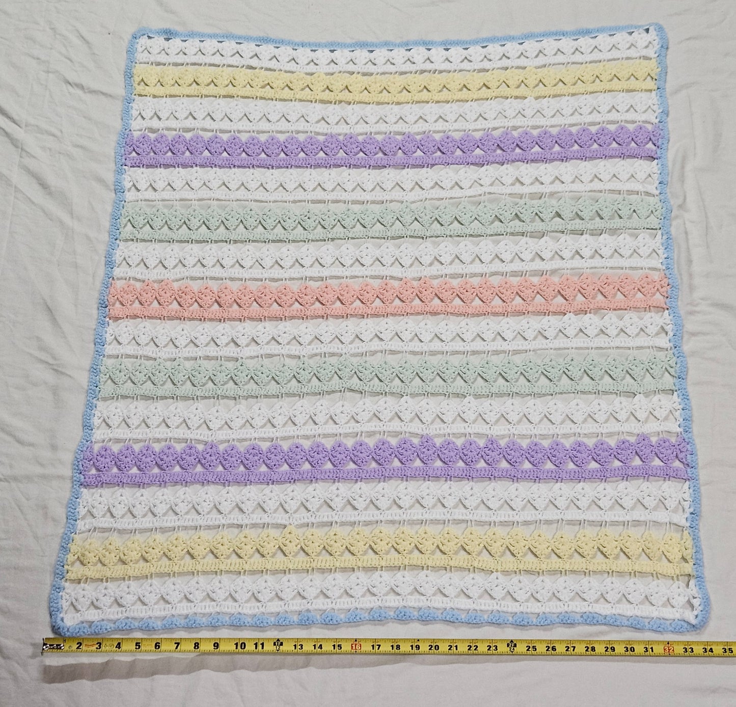 43" x 34" lacy crocheted decorative blanket in pastel colors