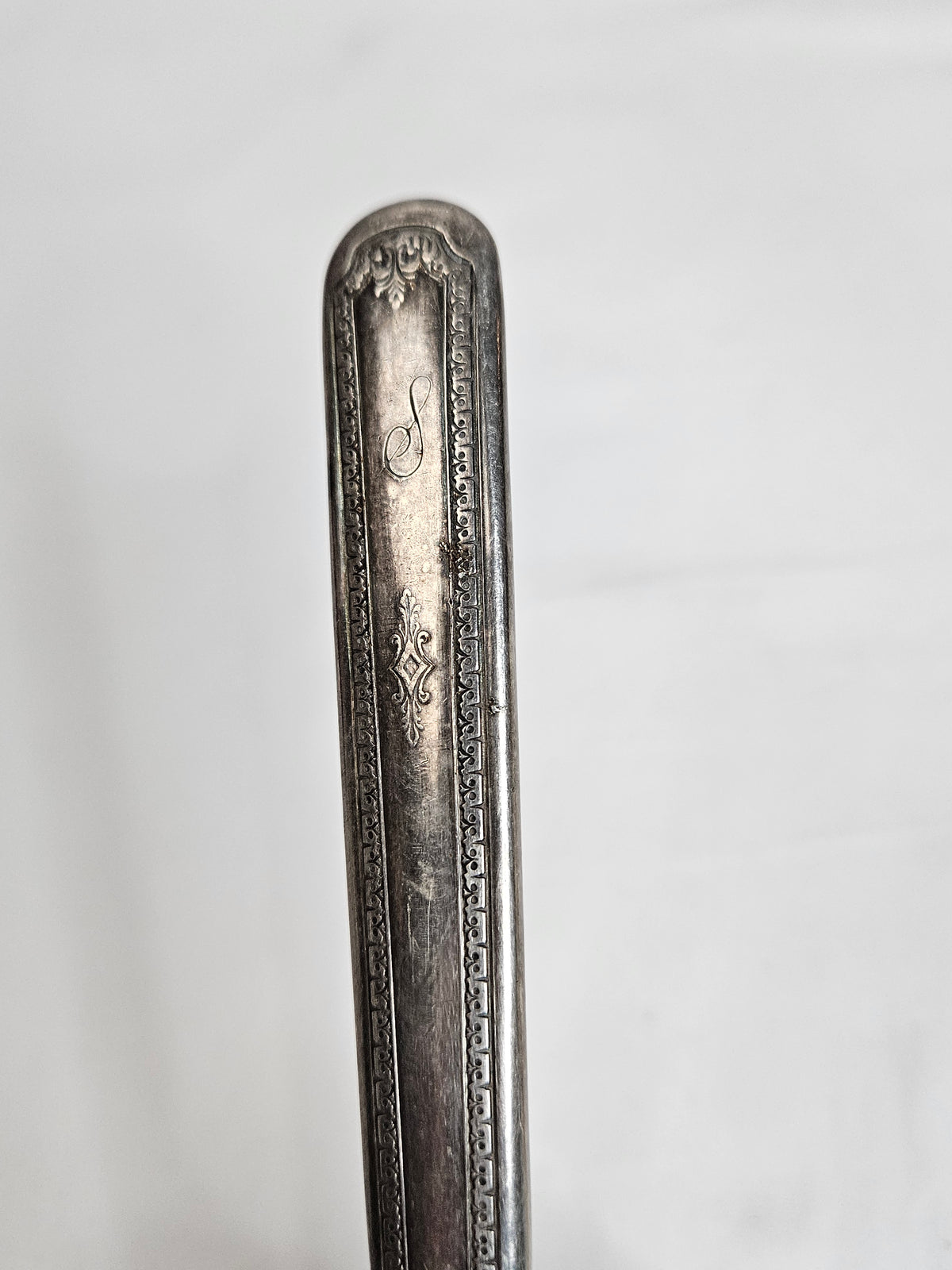 Vintage WM A Rogers serrated cake knife with an S monogram, 10 inches