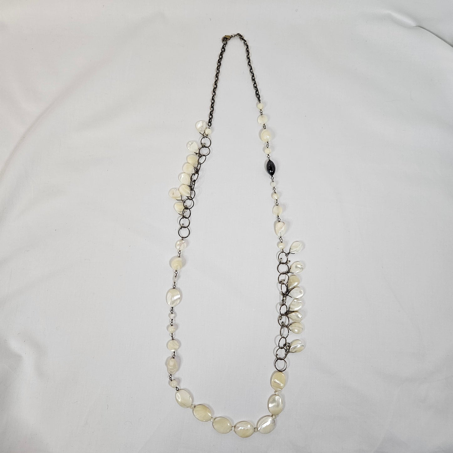 Asymmetric long necklace with mother of pearl beads and silver hoops and chain