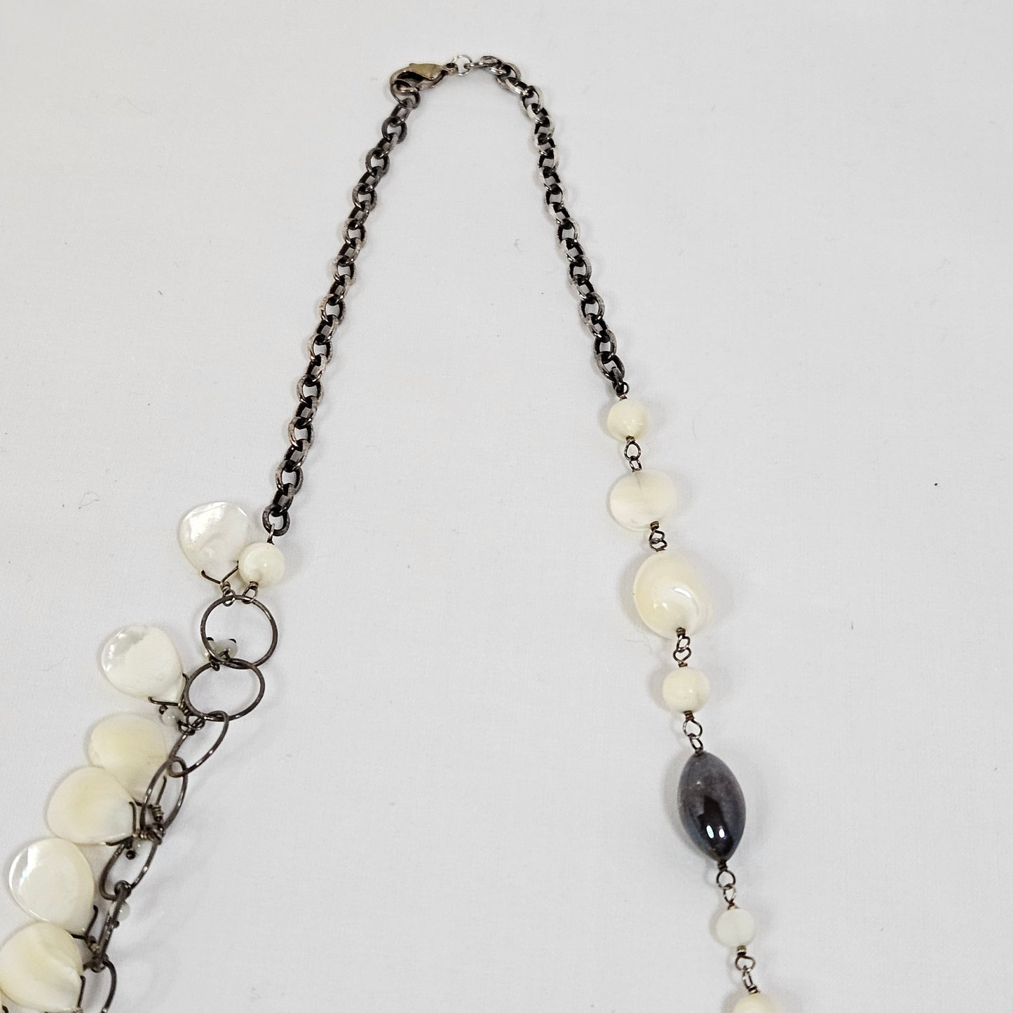 Asymmetric long necklace with mother of pearl beads and silver hoops and chain