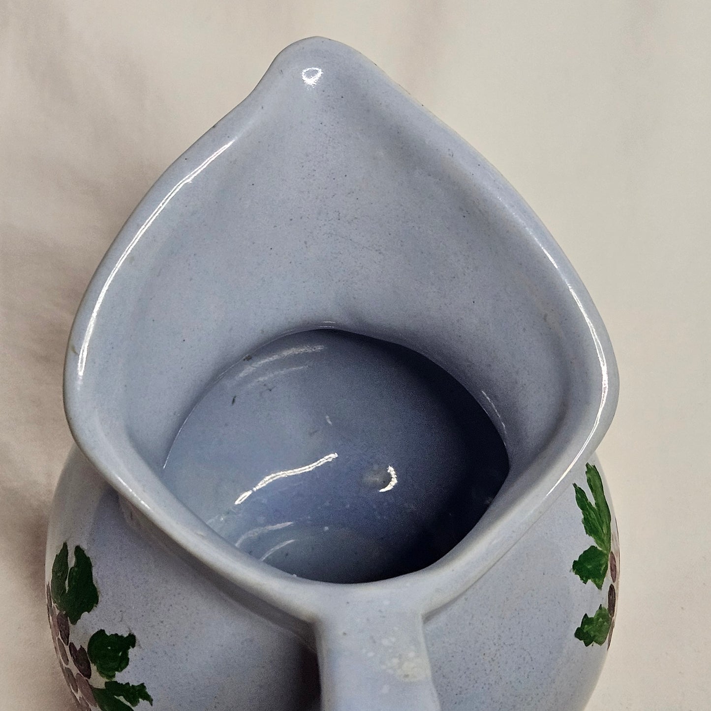 Vintage Niloak Pottery small light blue pitcher with hand-painted grape clusters