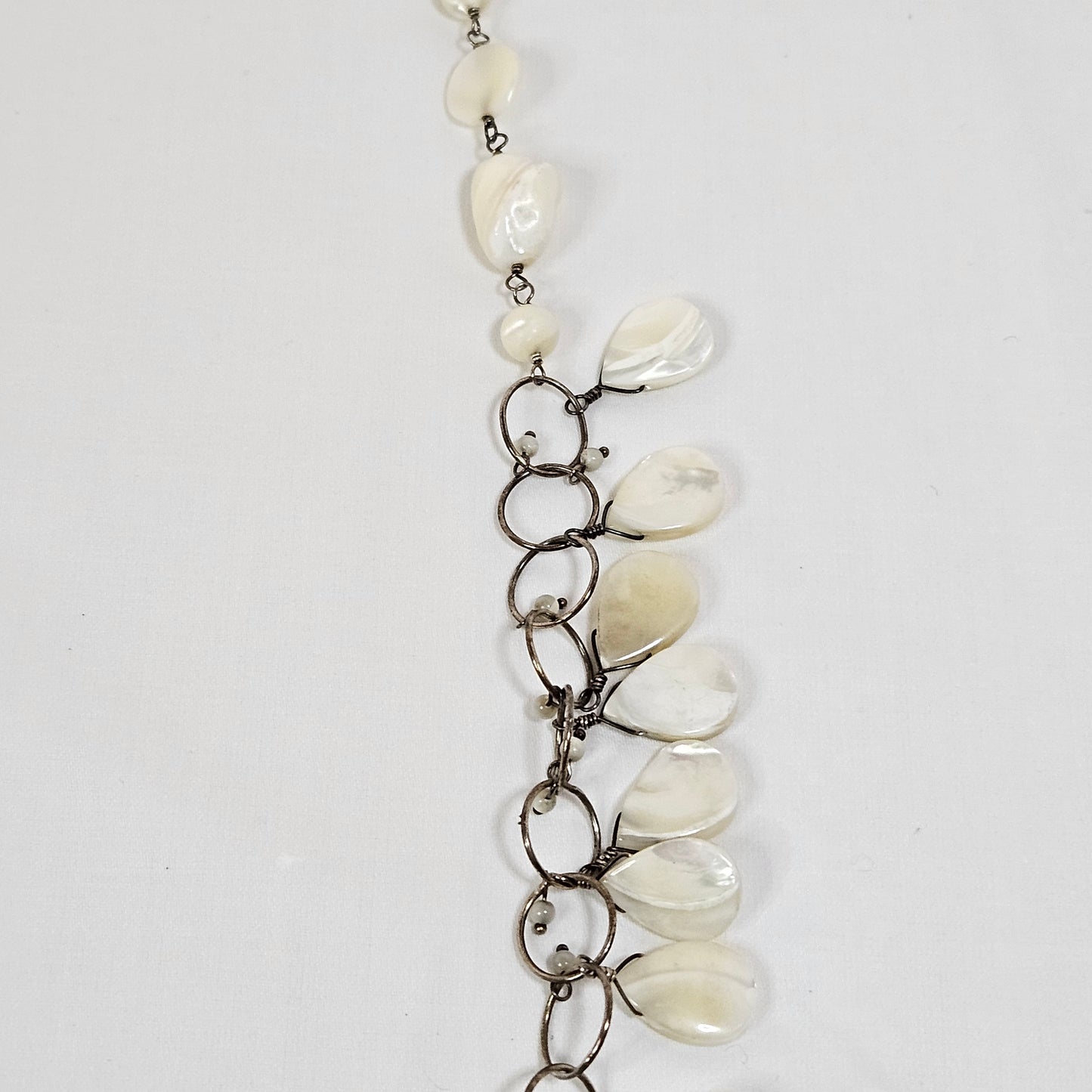 Asymmetric long necklace with mother of pearl beads and silver hoops and chain