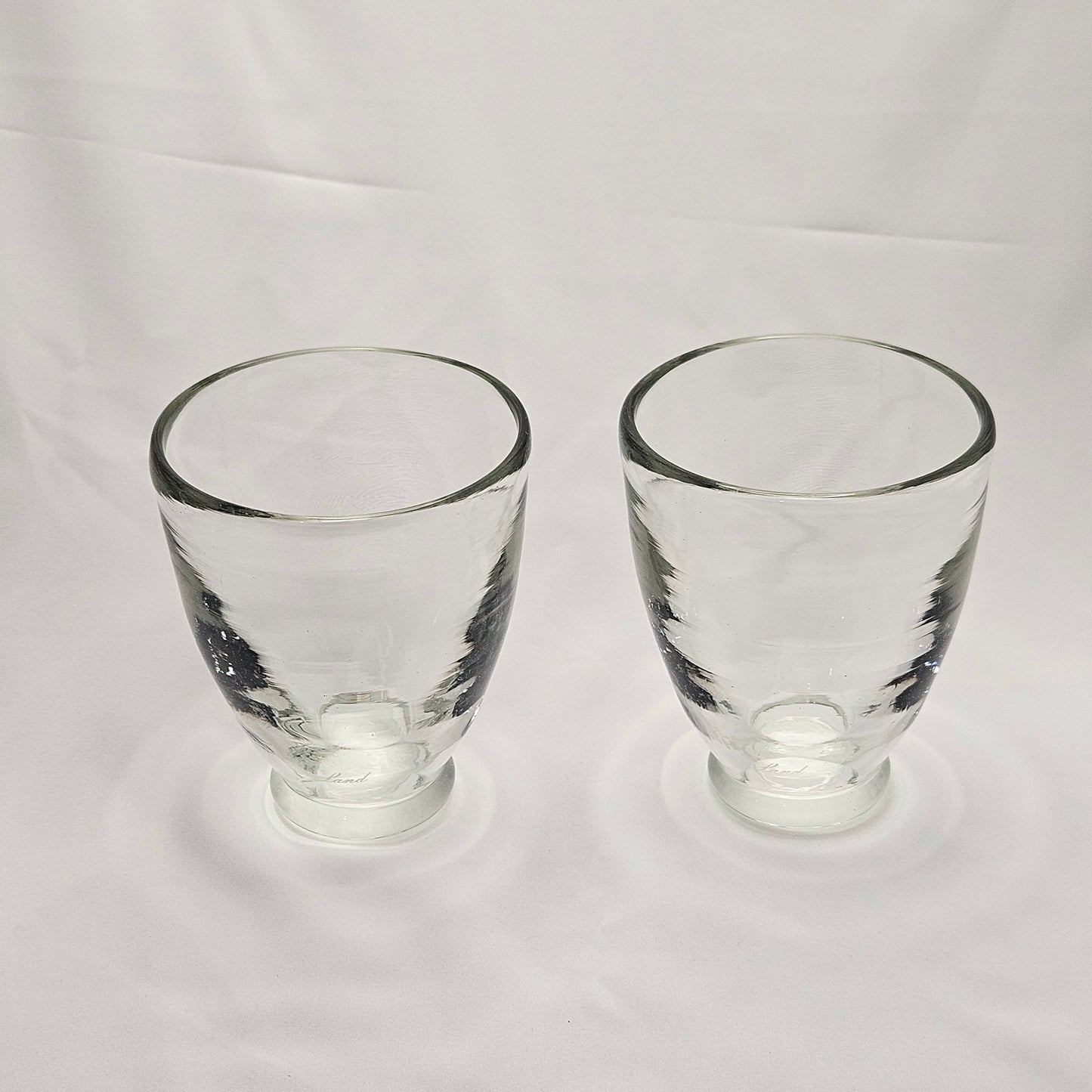Art glass heavy tumblers, two 4" glasses, hand-blown and engraved "Land"