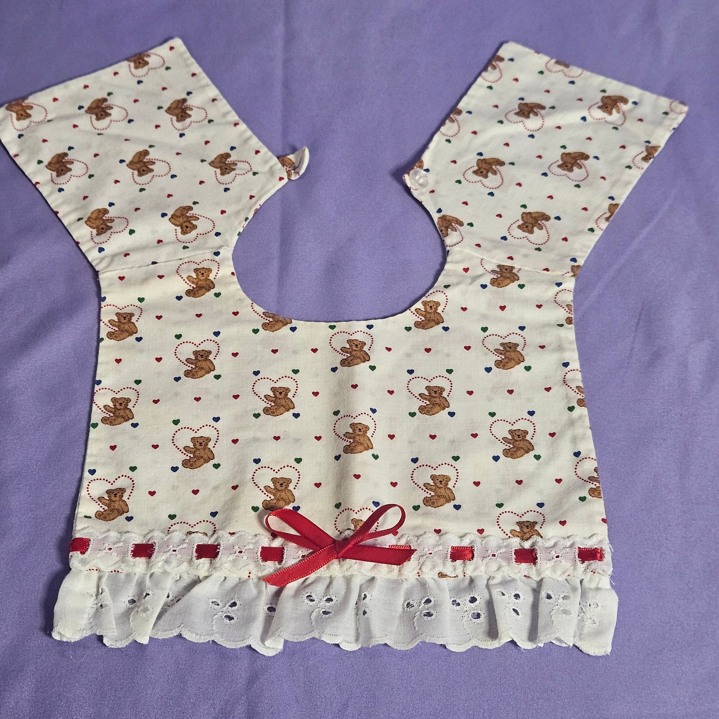 Handmade cotton bib,  teddy bear with hearts, ruffle trim and ribbon accent