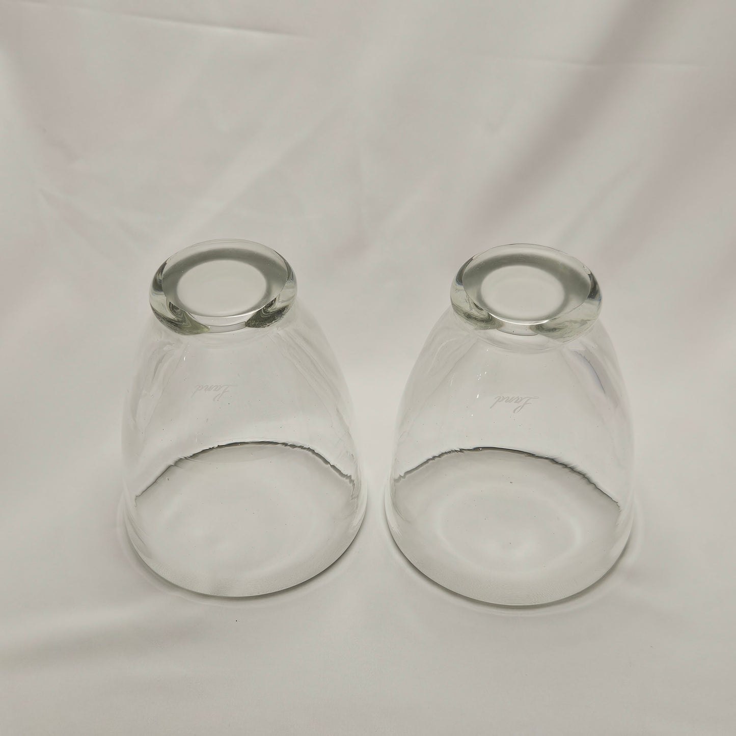 Art glass heavy tumblers, two 4" glasses, hand-blown and engraved "Land"