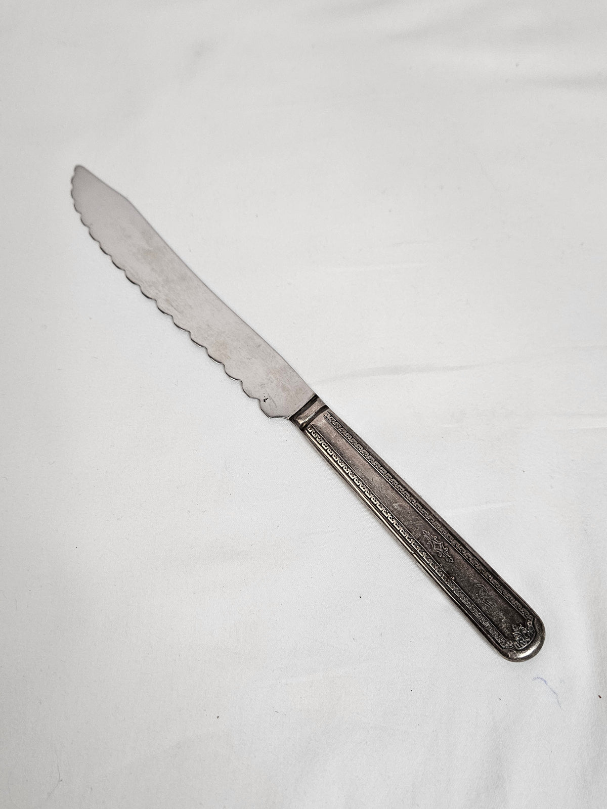 Vintage WM A Rogers serrated cake knife with an S monogram, 10 inches