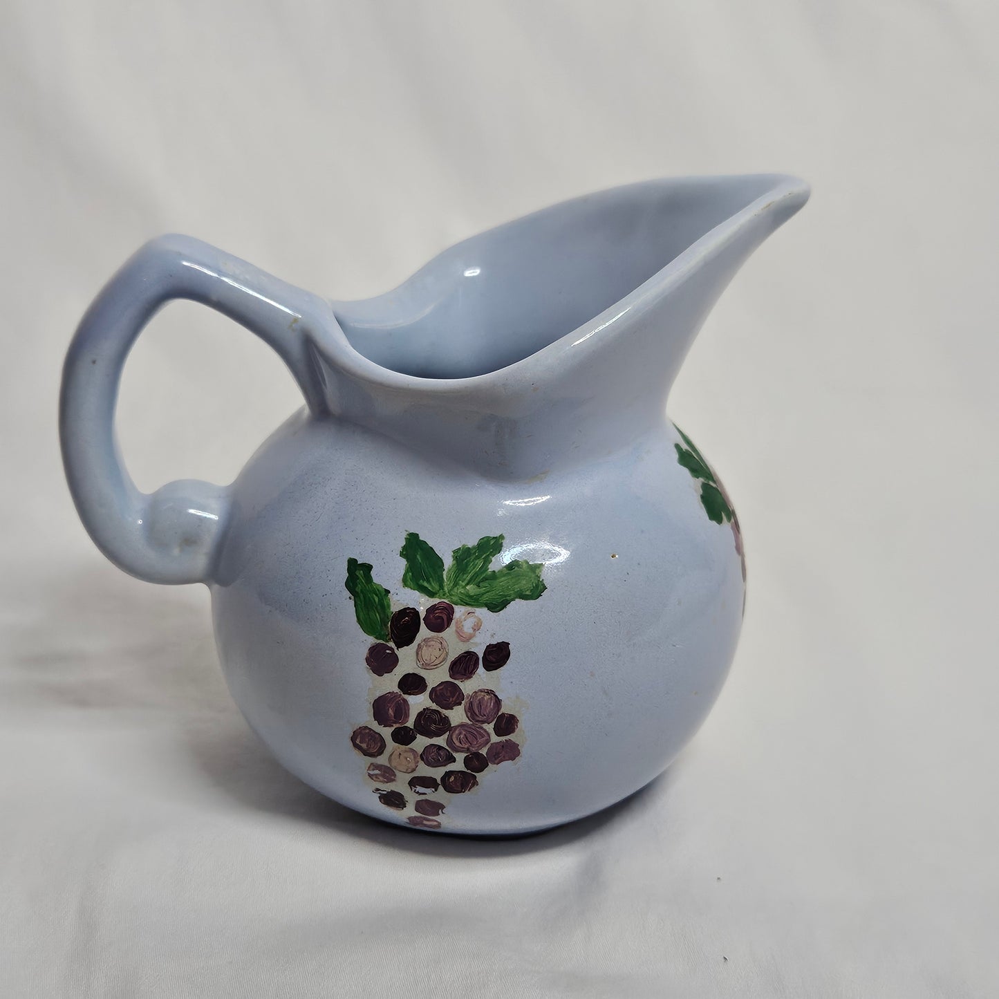 Vintage Niloak Pottery small light blue pitcher with hand-painted grape clusters