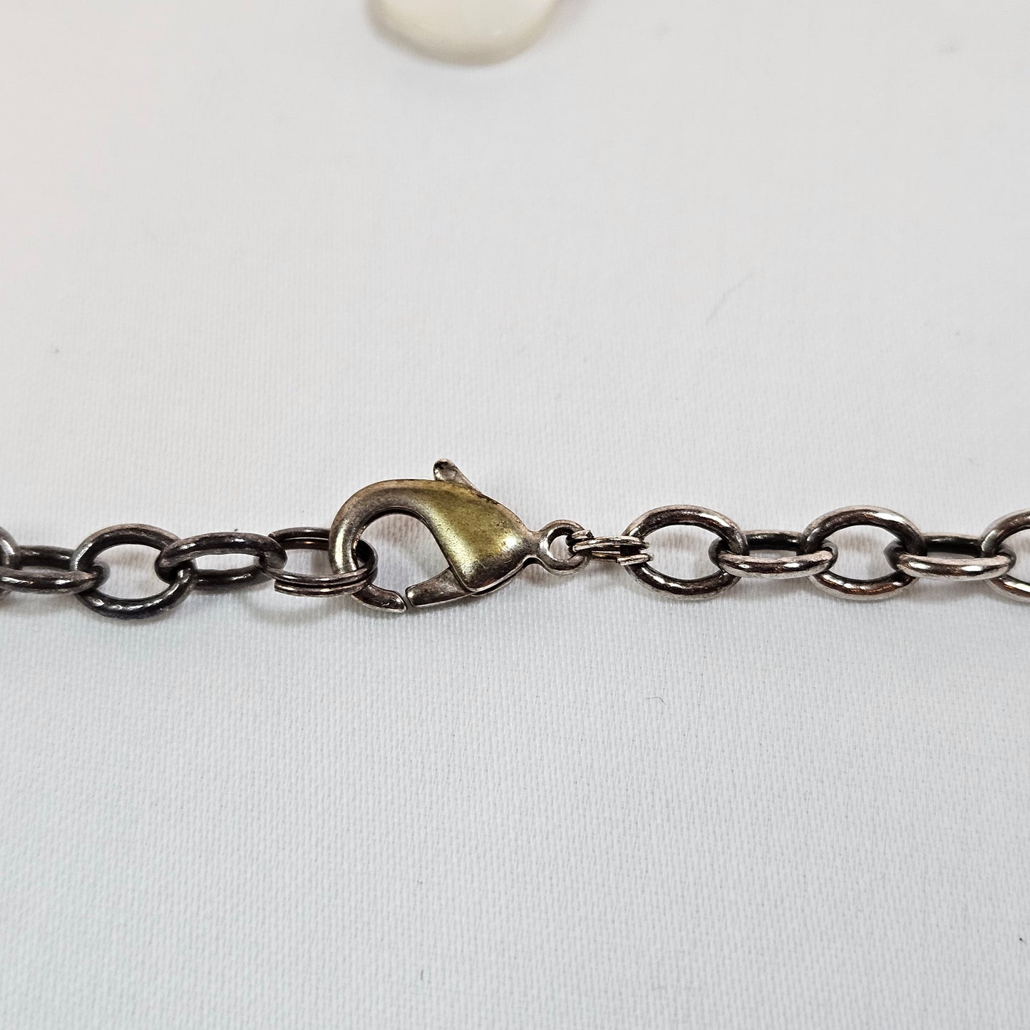 Asymmetric long necklace with mother of pearl beads and silver hoops and chain