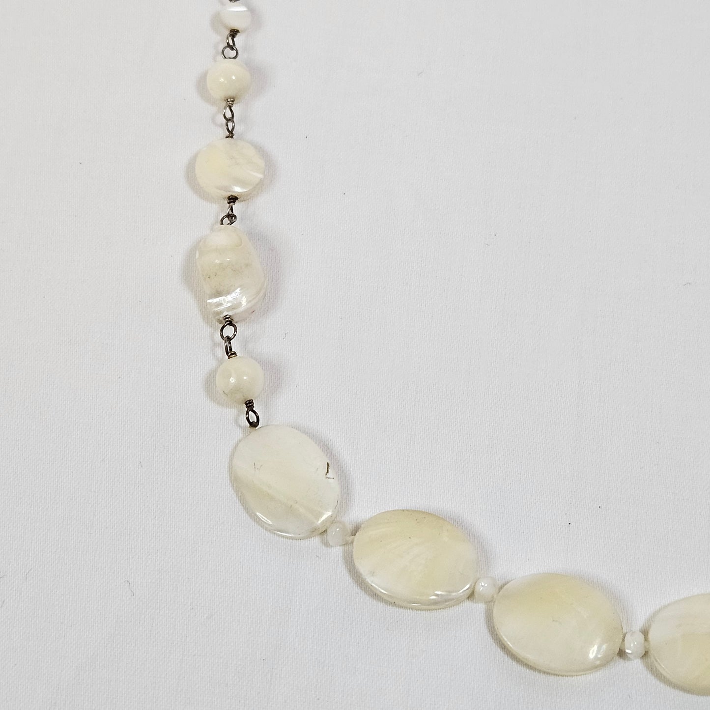 Asymmetric long necklace with mother of pearl beads and silver hoops and chain
