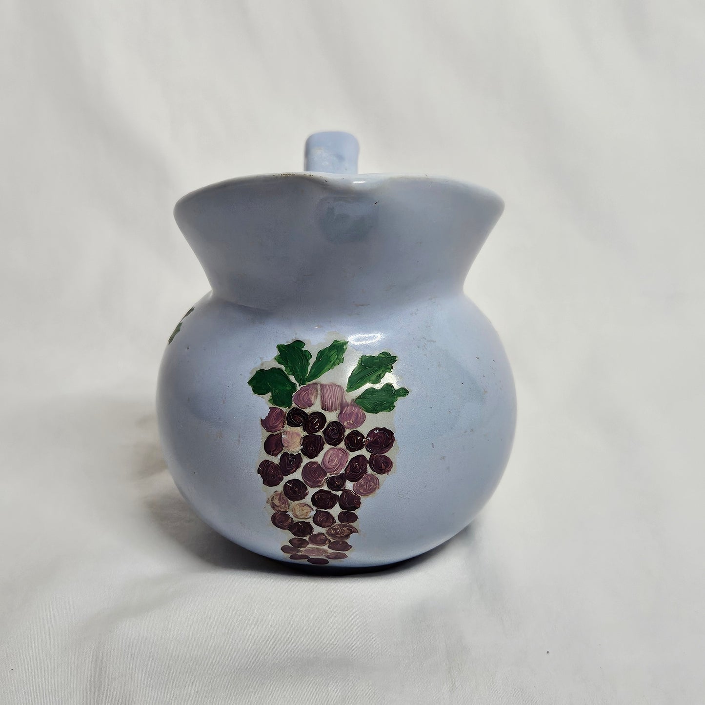 Vintage Niloak Pottery small light blue pitcher with hand-painted grape clusters