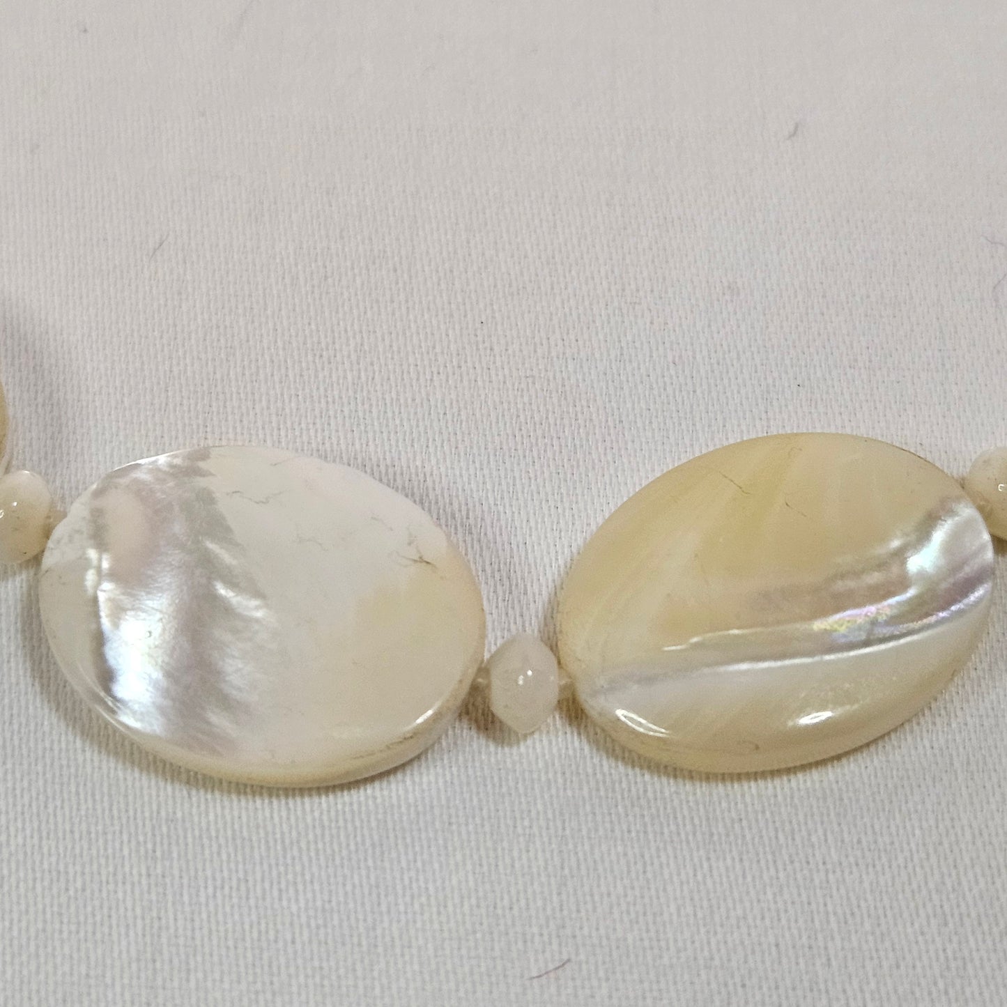 Asymmetric long necklace with mother of pearl beads and silver hoops and chain